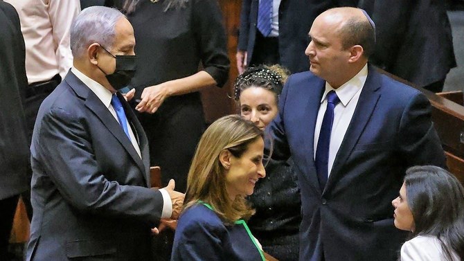 Benjamin Netanyahu and Naftali Bennett in the Knesset, Jerusalem, June 13, 2021. (AFP)