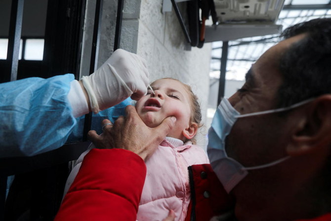 A Palestinian girl is tested for COVID-19 in light of the outbreak in Nablus, the Israeli-occupied West Bank, on Monday. (Reuters)