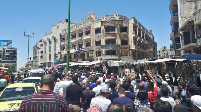 In this photo released by news site Suwayda 24 on June 9, 2020, Syrians stage a rare protest against the deteriorating economic conditions in the country. (AFP file photo)