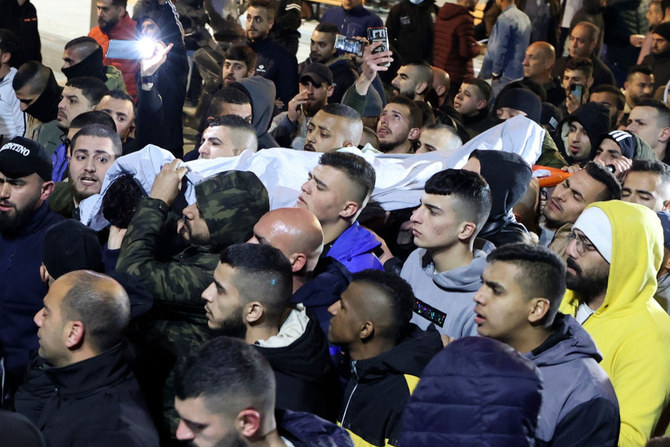 Palestinians carry the body of Mohamad Saleh, who was killed by Israeli forces during clashes in the occupied West Bank village Al Yamun, near Jenin on Feb. 14, 2022. (Jaafar Ashtiyeh / AFP)