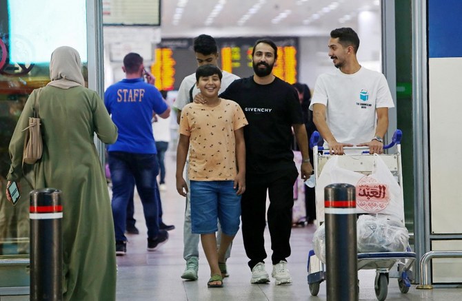 Travelers arrive at Kuwait international airport in Kuwait City. (File/AFP)