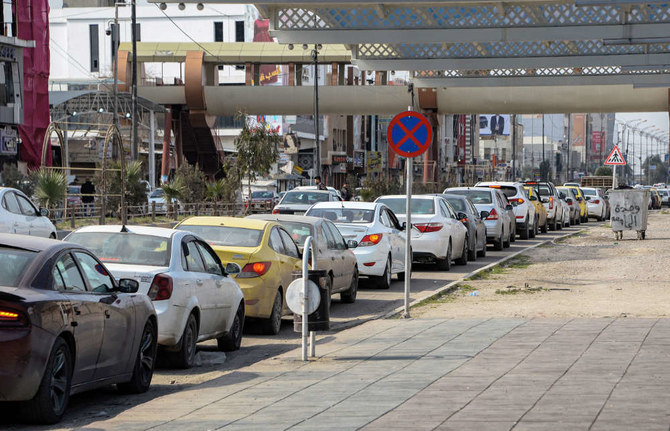 Vehicles queue up to refill on fuel in Iraq's northern city of Mosul on February 18, 2022. (AFP)