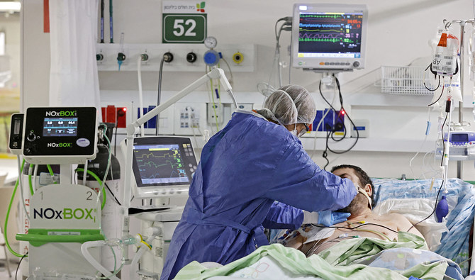 A medical staff member tends to a coronavirus patient at Beilinson Hospital Rabin Medical Center in Israel's central city of Petah Tikva. (AFP/File)