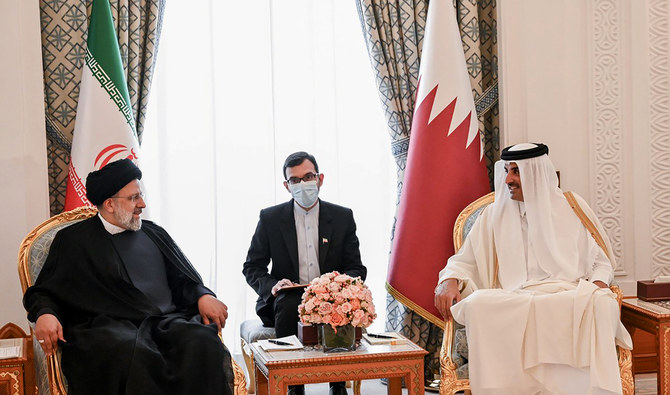 Iranian President Ebrahim Raisi, left, meets with Qatari Emir Tamim bin Hamad Al Thani, in Doha, Qatar, Monday, Feb. 21, 2022. (AP)