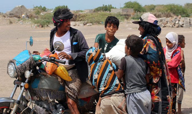 Yemenis displaced by conflict, receive food aid and provisions to meet heir basic needs, at a camp in the Khokha district of Yemen's war-ravaged western province of Hodeida, on February 23, 2022. (AFP)