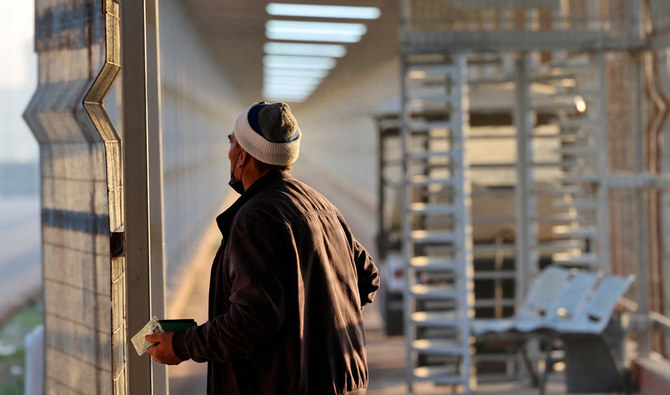 A Palestinian worker leaves Beit Hanun in the northern Gaza Strip through the Erez crossing to go to work inside Israel on February 23, 2022. (AFP)