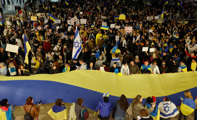 Demonstrators wave a giant Ukrainian national flag during a protest on Feb. 26, 2022, in front of the Russian embassy in Tel Aviv, Israel. (Jack Guez / AFP)