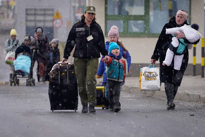 People fleeing the Russian invasion in Ukraine cross the border into Poland. (Reuters)