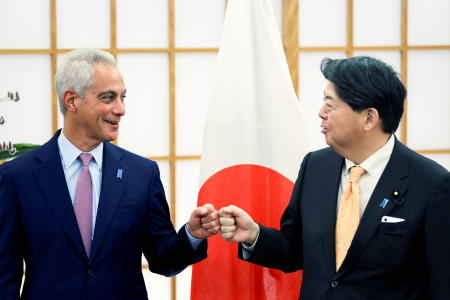 Japan's Foreign Minister Yoshimasa Hayashi (right) fist bumps with new US ambassador to Japan Rahm Emanuel during a meeting in Tokyo on February 1, 2022. (AFP)