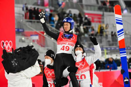 Japan's Ryoyu Kobayashi (centre) celebrates winning the Ski Jumping Men's Normal Hill Individual Final Round on February 06, 2022 at the Zhangjiakou National Ski Jumping Centre during the Beijing 2022 Winter Olympic Games. (AFP)