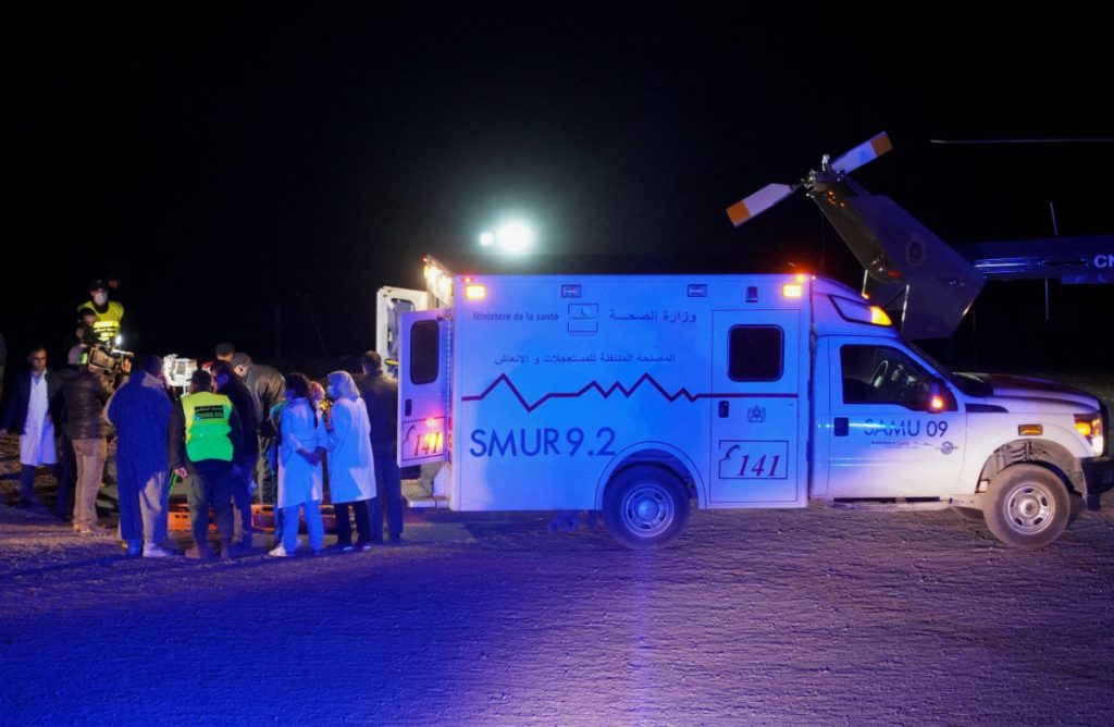 Medics and rescuers inspect the body of Rayan Awram after he was extracted from the well on Feb. 5, 2022. (REUTERS/Abdelhak Balhaki)
