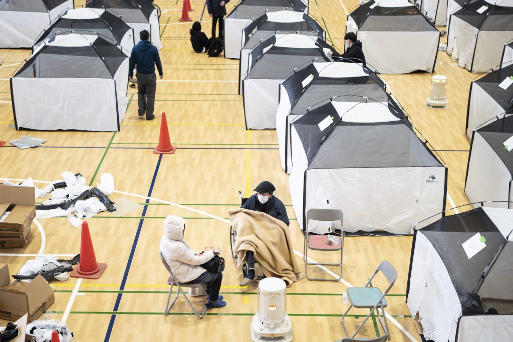 Earthquake-affected residents shelter in an omnisport venue in Soma, Fukushima Prefecture on March 17, 2022, after a 7.3-magnitude quake jolted east Japan the night before. (AFP)