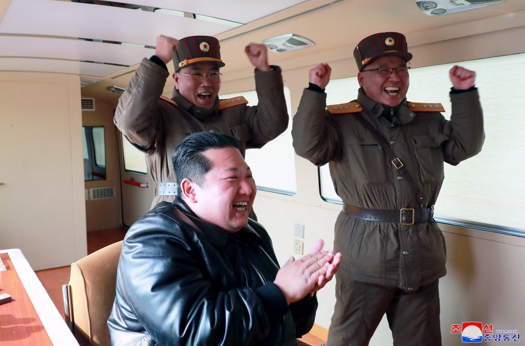 This picture taken on March 24, 2022 and released from North Korea's official Korean Central News Agency (KCNA) on March 25, 2022 shows North Korean leader Kim Jong Un (C) reacting during the test launch operation of a new type inter-continental ballistic missile (ICBM), Hwasongpho-17. (AFP)