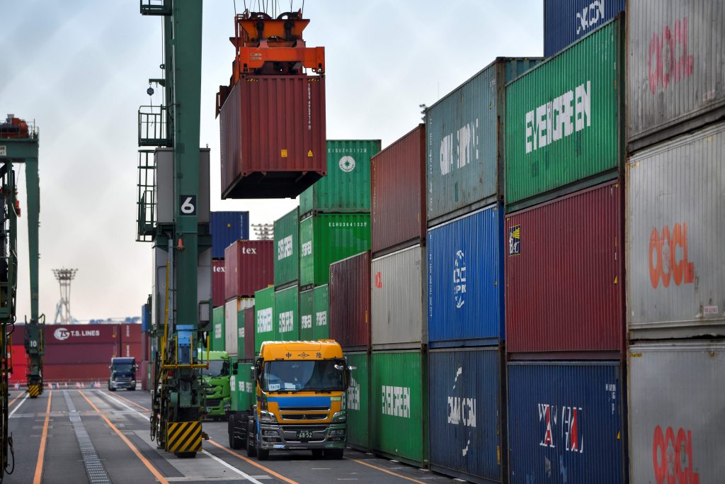 Cargo containers are loaded on and off trucks at the international cargo terminal at the port in Tokyo. (AFP)