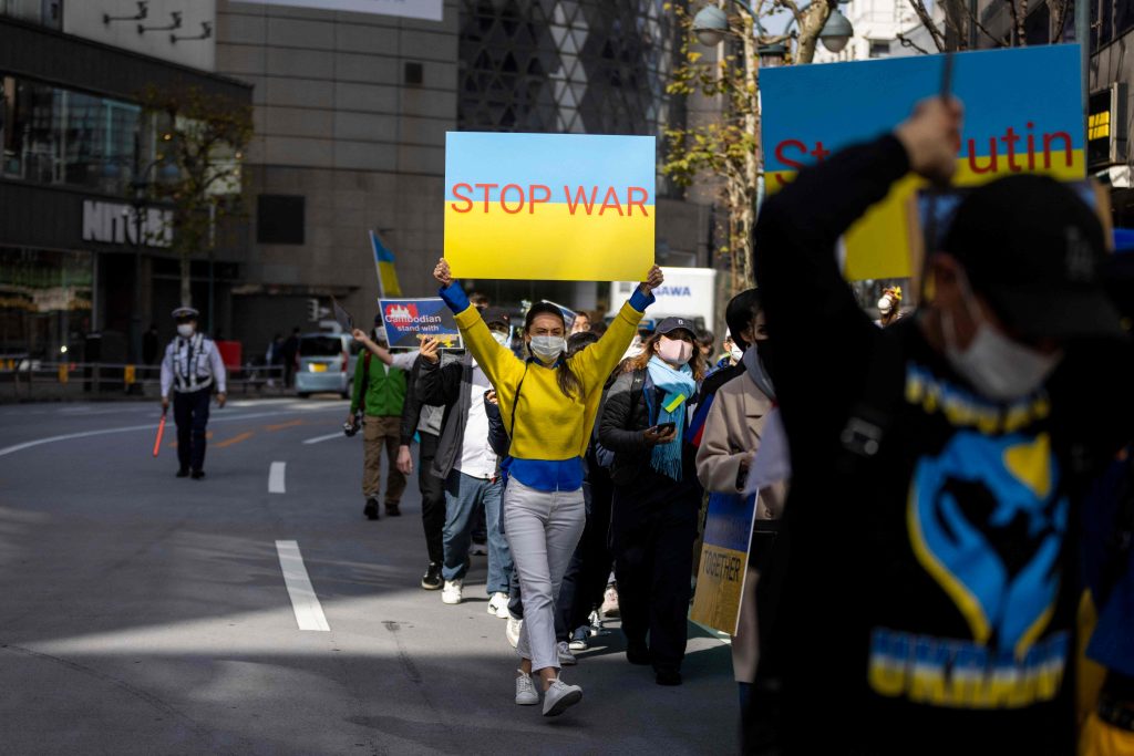 Protestors hold placards as they take part in a protest against Russia's actions in Ukraine, during a rally in Tokyo on March. 5, 2022. (File photo/AFP)