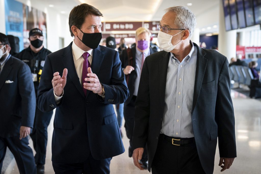 Sen. Bill Hagerty, R-Tenn., left, walks with Greg Kelly, right, a former Nissan executive, at Nashville International Airport in Nashville, Tenn., March 14, 2022. (File photo/The Tennessean via AP)