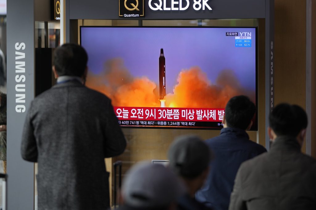 People watch a TV screen showing a news program reporting about North Korea's missile with file footage, at a train station in Seoul, South Korea, Wednesday, March 16, 2022. (File Photo/AP)