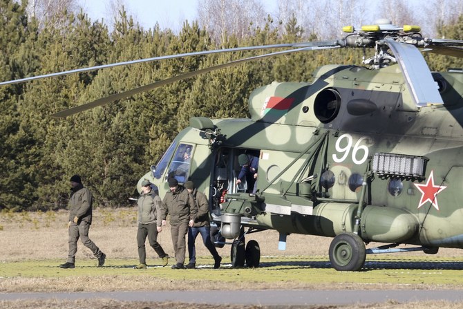 The Ukrainian delegation leaves a Belarusian military helicopter upon their landing in Gomel region, Belarus, Monday, Feb. 28, 2022. (AP)