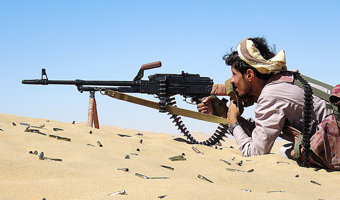 A Yemeni pro-government fighter takes aim from his position during fighting with Houthis on the Al-Jawba frontline south of Marib. (AFP/File)