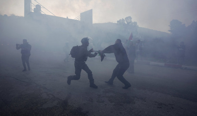 Palestinian protesters scuffles with Israeli security forces during a demonstration against Jewish settlers before tried blocked Palestinian children from entering a school in Nablus, Feb. 27, 2022. (AP)