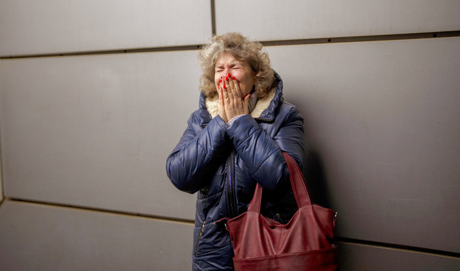 A woman cries as she says goodbye to her daughter and grandson on a train to Lviv at the Kyiv station, Ukraine. (AP)