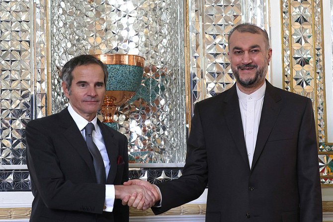 International Atomic Energy Agency chief Rafael Grossi (left) is welcomed by Iranian FM Hossein Amir-Abdollahian (R) welcomes Head of the in the capital Tehran on March 5, 2022. (AFP)