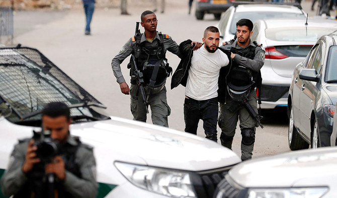 Israeli security forces arrest a Palestinian man in the East Jerusalem neighbourhood of Sheikh Jarrah, where Jewish settler groups have sought to seize control. (AFP/File)