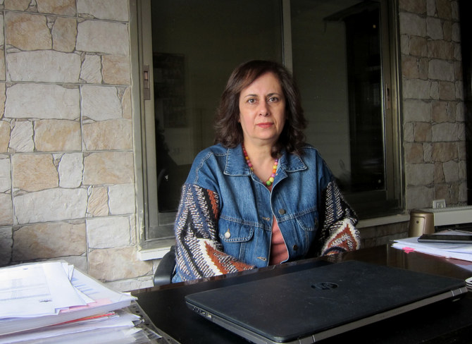 Rula Salameh, a Palestinian feminist activist from East Jerusalem, speaks to Arab News at her office on March 6. (AN Photo by Mohammed Najib)