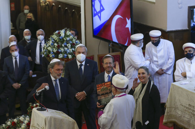 Israel’s President Isaac Herzog and his wife Michal Herzog gestures during their visit to Neve Shalom synagogue, in Istanbul on Thursday. (AP)