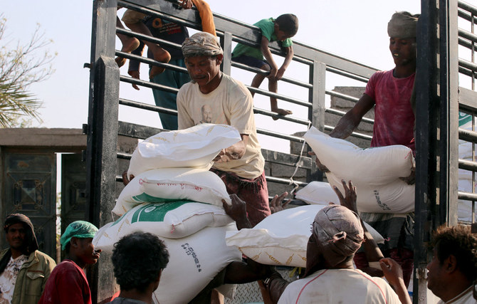 Workers prepare food aid to be distributed to Yemenis displaced by conflict in Yemen's war-ravaged western province of Hodeidah on March 1, 2022. (Photo by Khaled Ziad / AFP)