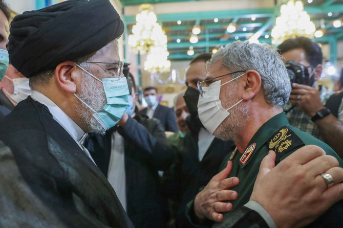 Iran's President Ebrahim Raisi (L) greets Brig. Gen. Esmail Qaani, commander of the notorious Quds Force, during an event on March 13, 2022, in Tehran. (Iranian Presidency photo via AFP)