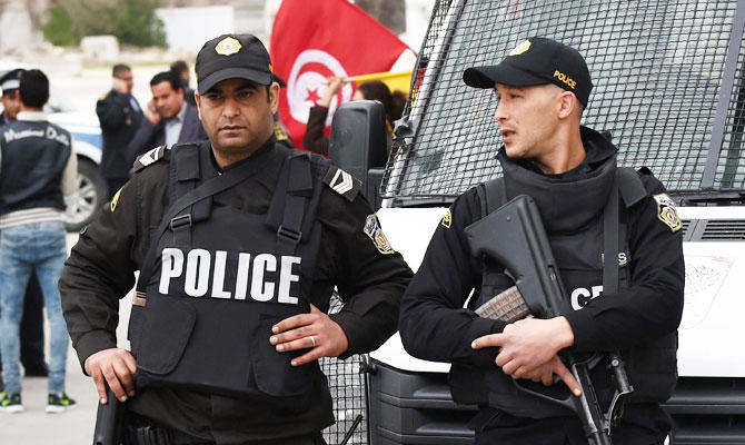 Policemen stand guard in Tunis. (AFP)
