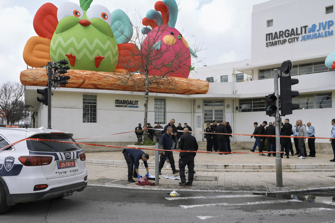 Israeli police examine the scene of a stabbing attack in Jerusalem. Israeli police say the alleged Palestinian attacker has been shot and injured after stabbing a man in Jerusalem. (AP)