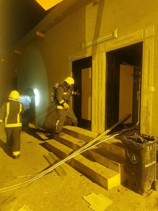 Saudi firefighters inspect the damage caused by the debris of a missile intercepted in Jazan on Saturday night. (SPA)