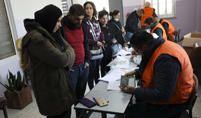 People register to vote in the Palestinian local elections in the occupied West Bank city of Al-Bireh city, on March 26, 2022. (AFP)