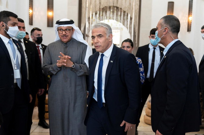Bahrain’s Foreign Minister Abdullatif bin Rashid Aal-Zayani walks with Israel’s Foreign Minister Yair Lapid during the Negev Summit in Sde Boker, Israel on March 28, 2022. (Reuters)