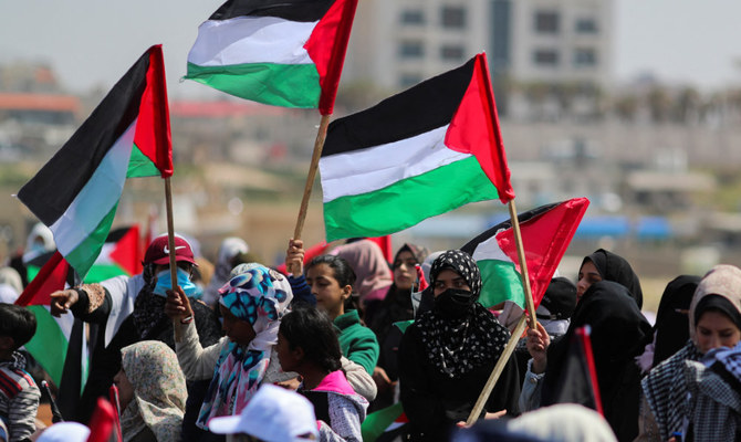 Palestinian demonstrators gather during a protest marking 'Land Day' at the seaport of Gaza City March 30, 2022. (Reuters)