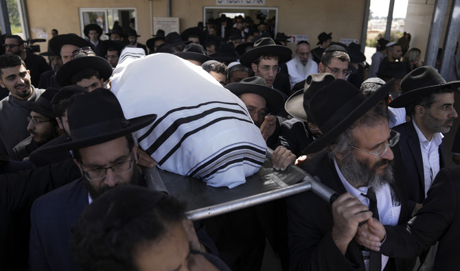 Mourners carry the body of Yaakov Shalom, 36, during his funeral in Petah Tikva, Israel, Wednesday, March 30, 2022. Shalom was one of five killed by a gunman in a crowded city in central Israel late Tuesday. (AP)