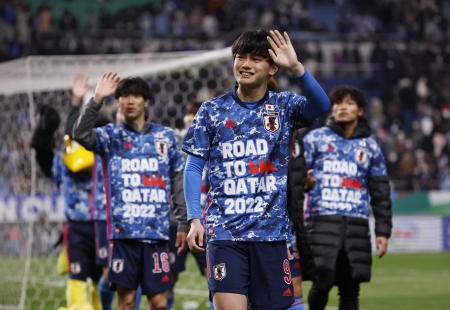 Japan's Ayase Ueda and teammates wave to fans after the match during a ceremony for qualifying for the World Cup. (Reuters)