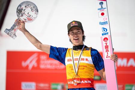 Japan's Ryoyu Kobayashi celebrates with the crystal globe trophy after winning the overall FIS Ski Jumping World Cup in Planica, Slovenia on March 27, 2022. (AFP)