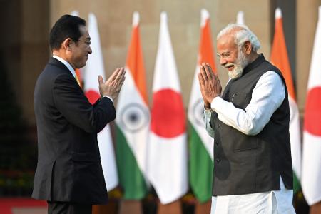 Japan's Prime Minister Fumio Kishida (left) and his Indian counterpart Narendra Modi gesture as they pose for pictures before their meeting at the lawns of the Hyderabad House in New Delhi on March 19, 2022. (AFP)