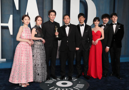 Ryusuke Hamaguchi (centre) holds his Oscar as he poses with the cast of his film “Drive My Car” as they arrive at the Vanity Fair Oscar party during the 94th Academy Awards in Beverly Hills, California, US, March 28, 2022. (Reuters)