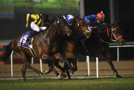 Lord North (centre) with jockey Frankie Dettori and Panthalassa (right) under Yutaka Yoshida finish in a dead heat in the Group 1 Dubai Turf. (AP)