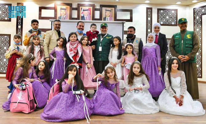 KSrelief chief Dr. Abdullah Al-Rabeeah pose for a group photo with Syrian orphans in Amman. (SPA)