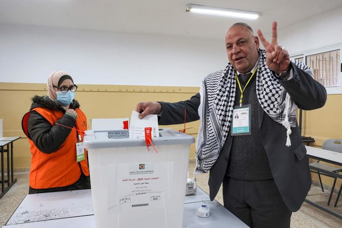 Sufian Al-Muhtaseb, a candidate for the Palestinian Fatah movement, casts his ballot in the city of Hebron in the occupied West Bank on March 26, 2022. (AFP)