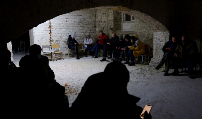 People take shelter in the basement of a school as air raid siren sounds are heard amid Russia's invasion of Ukraine, in Lviv, Ukraine, March 3, 2022. (Reuters)