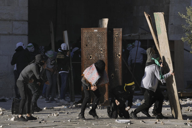 Palestinians clash with Israeli security forces at the Al Aqsa Mosque compound in Jerusalem’s Old City on Friday, April 15, 2022. (AP)