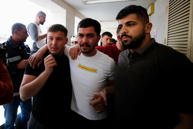Relatives of Ahmed Al-Atrash, a Palestinian protester killed, according to medics, by Israeli forces, pose at the hospital in Hebron, in the Israeli- occupied West Bank on Friday. (Reuters)