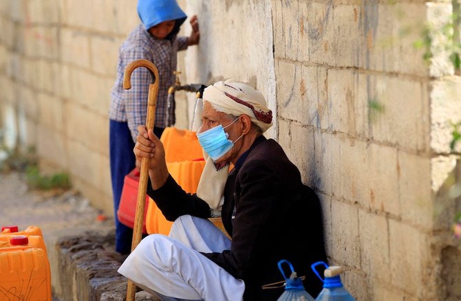 Yemenis fill their jerrycans with drinking water from a donated tank amid acute shortage in the capital Sanaa on March 31, 2022. (AFP)