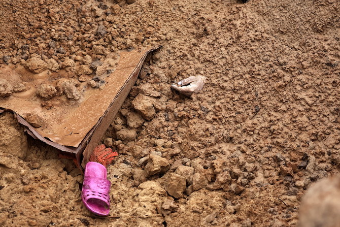 A civilian, who according to residents were killed by Russian army soldiers, is buried along with others in one grave, at Bucha in Kyiv region of Ukraine. (Reuters)